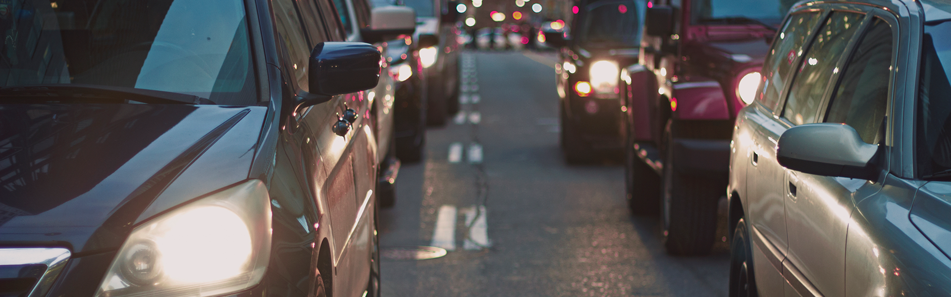Cars waiting in traffic on a busy road