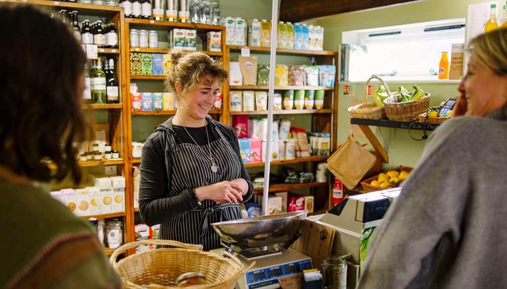 Alex Beer Feed The Soul owner serving customers at shop counter