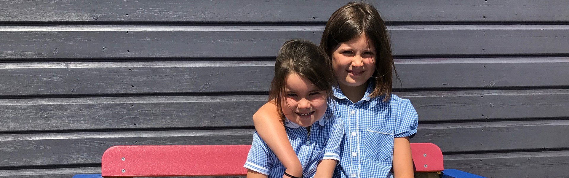 Sisters from Kehelland Village School sat on buddy bench together