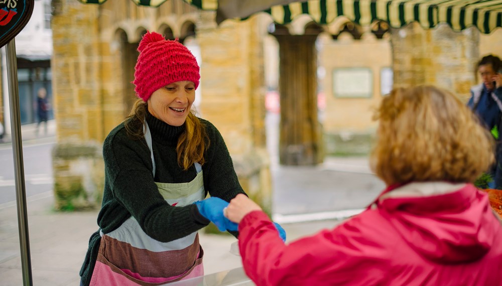 Karen Welford serving customer at stall