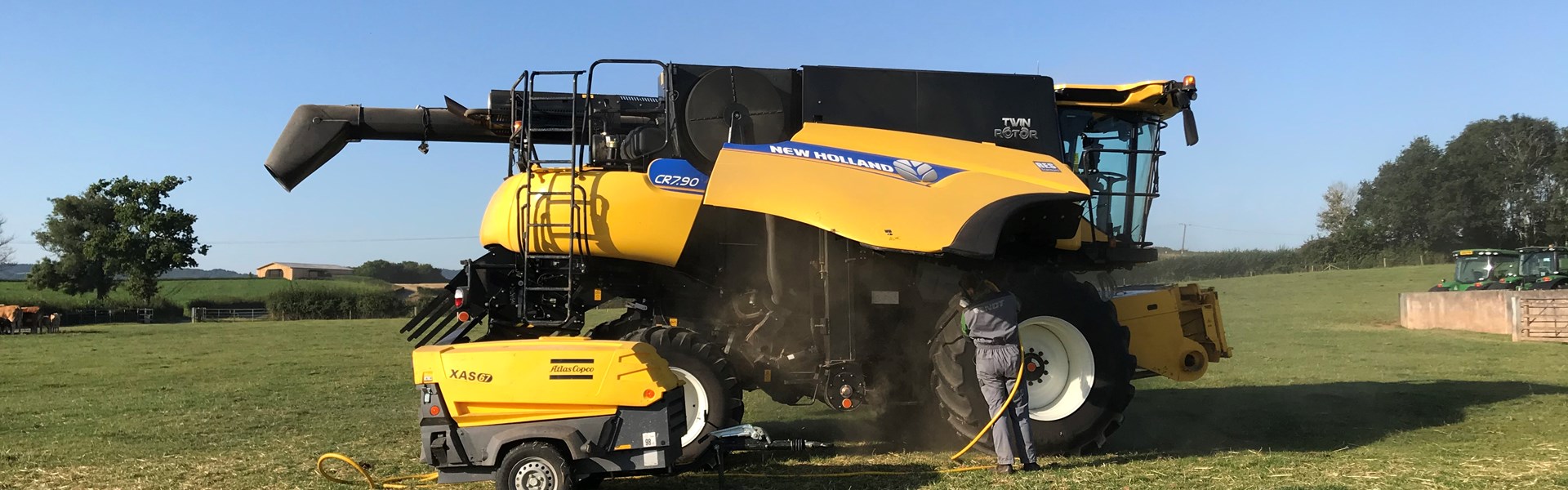 Farmer cleaning combine harvester